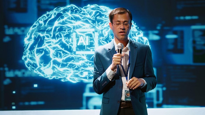 Speaker at Enterprise AI Architecture Summit with AI brain hologram